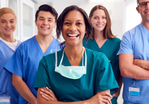  A diverse group of happy medical professionals in scrubs