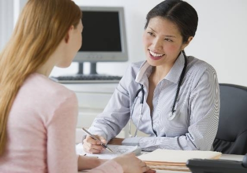 A nurse talking with a patient in a medical office