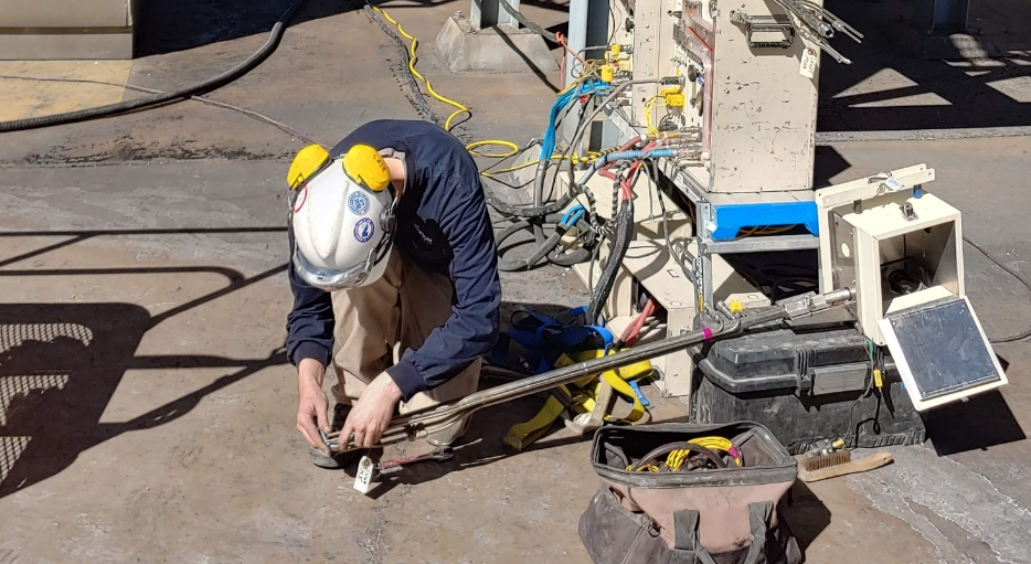 A technician working on a pipe.