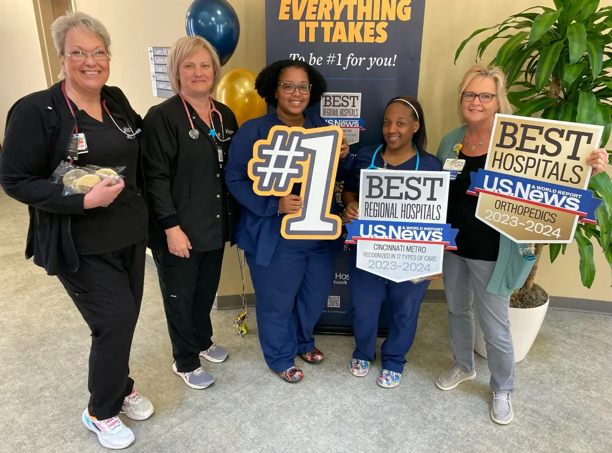 A group of Christ Hospital Health Network nurses holding signs to celebrate being the #1 Best Hospital in the Greater Cincinnati region.